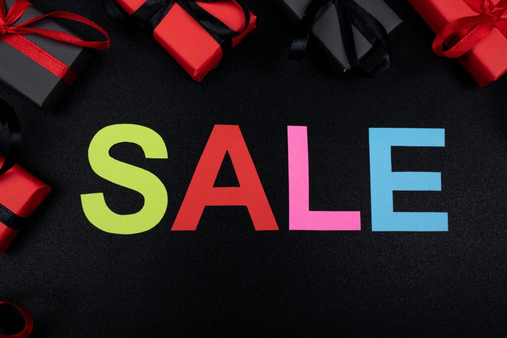Vibrant SALE text surrounded by gift boxes offers perfect promotional imagery.