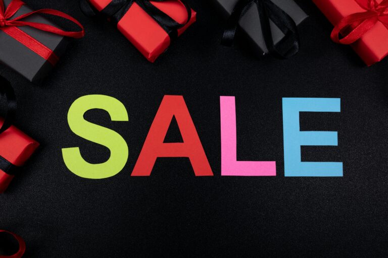 Vibrant SALE text surrounded by gift boxes offers perfect promotional imagery.